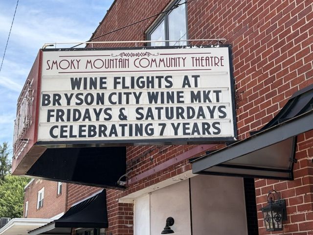 The Smoky Mountain Community Theatre marquee in Bryson City reading Wine Flights at Bryson City Wine Market, Fridays and Saturdays, Celebrating 7 Years